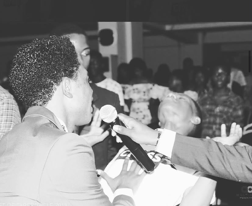 Pastor Kelvin ministering among the people