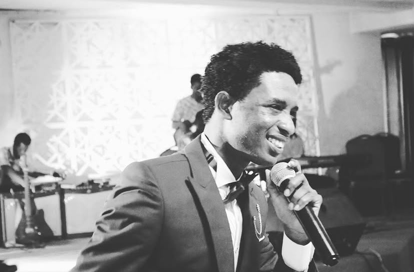 Pastor Kelvin with the microphone