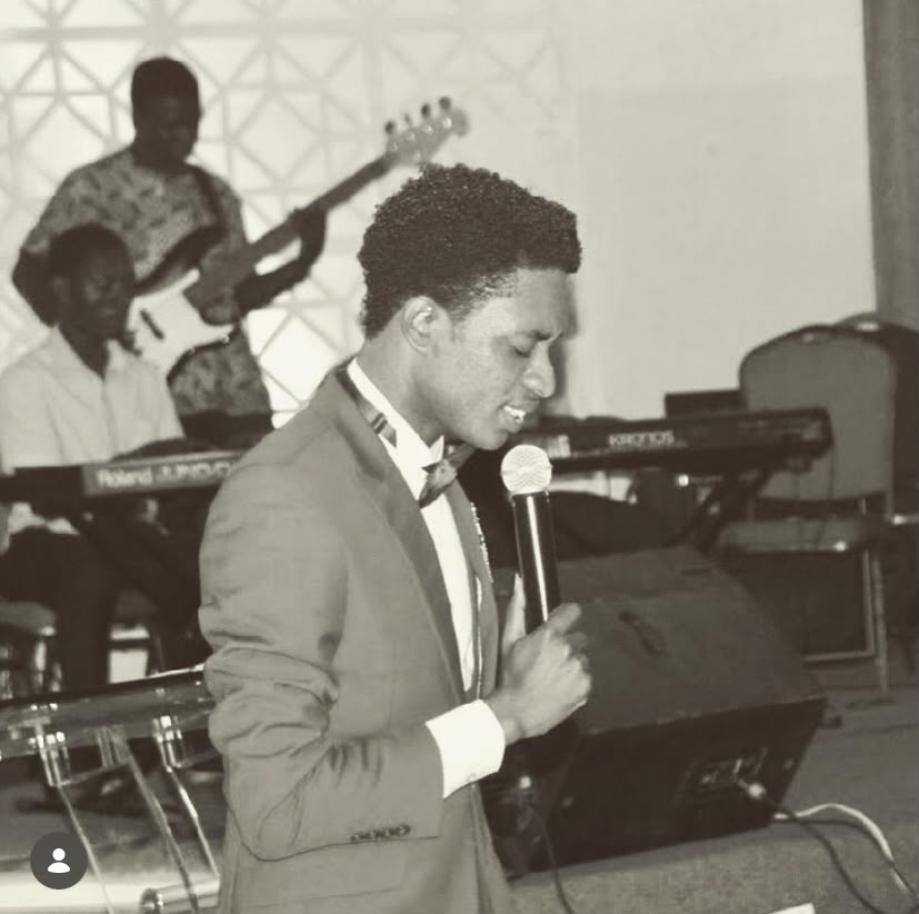 Pastor Kelvin singing with the band